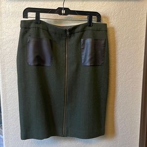 Wool fancy pencil skirt with brown leather pockets and gold front zipper.